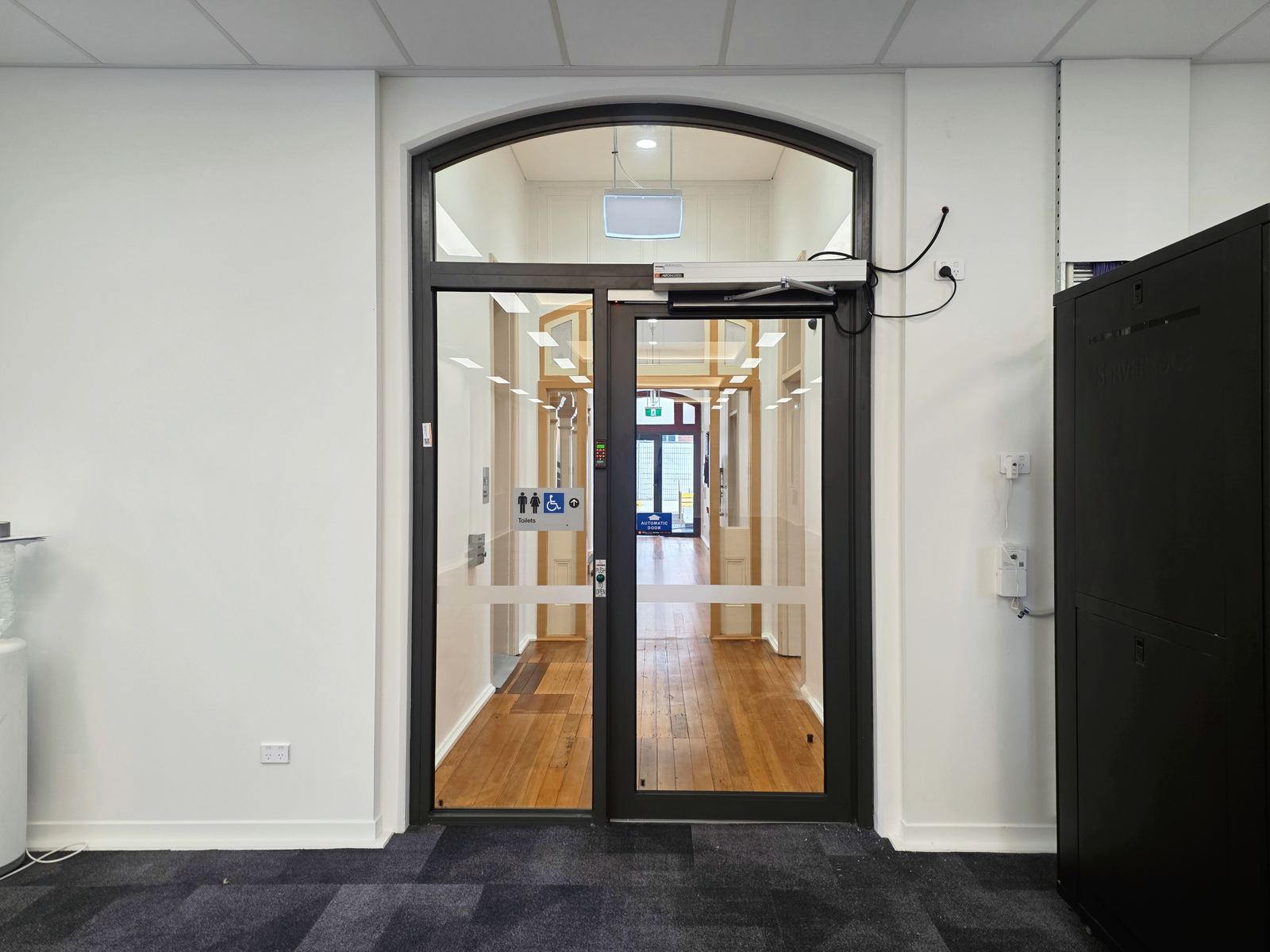 Interior arched aluminium door with automatic operator
