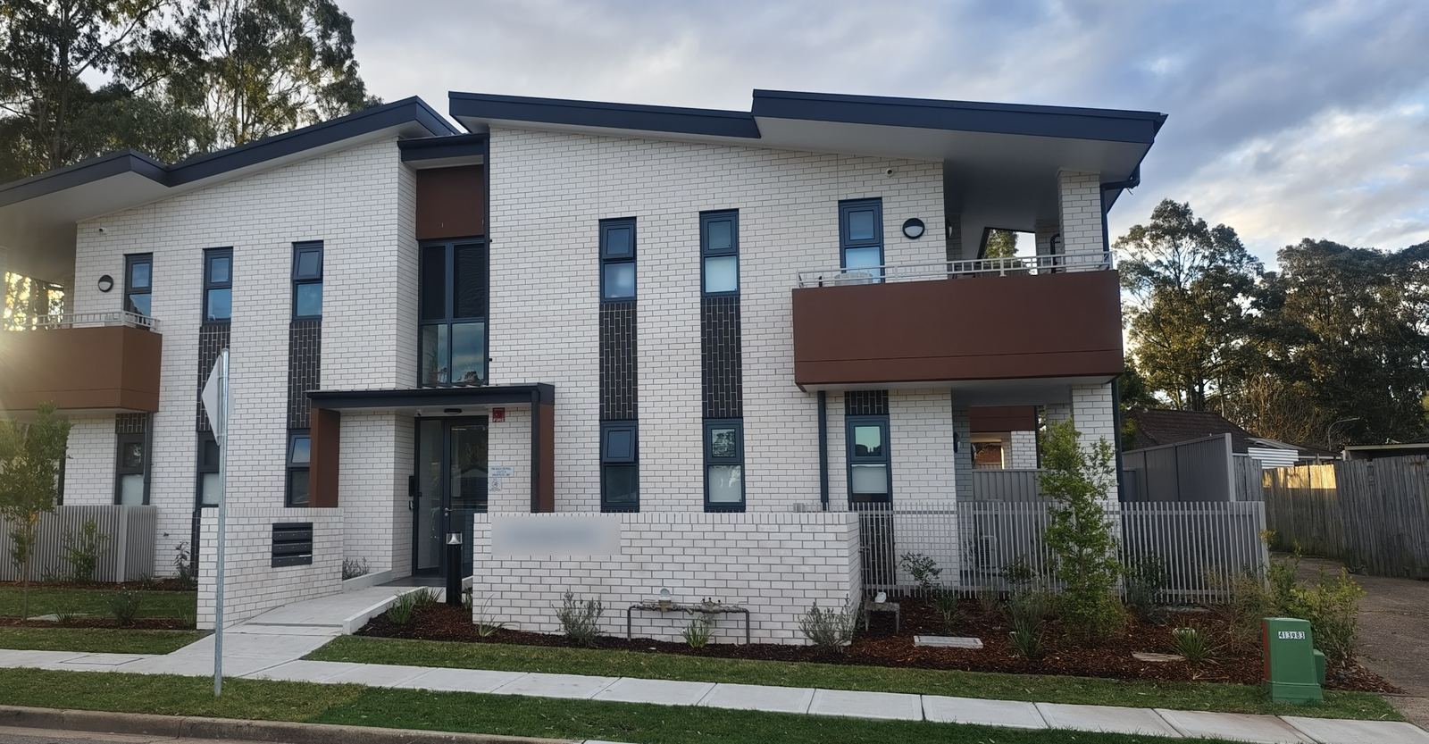 Modern white-brick apartment building with aluminium windows