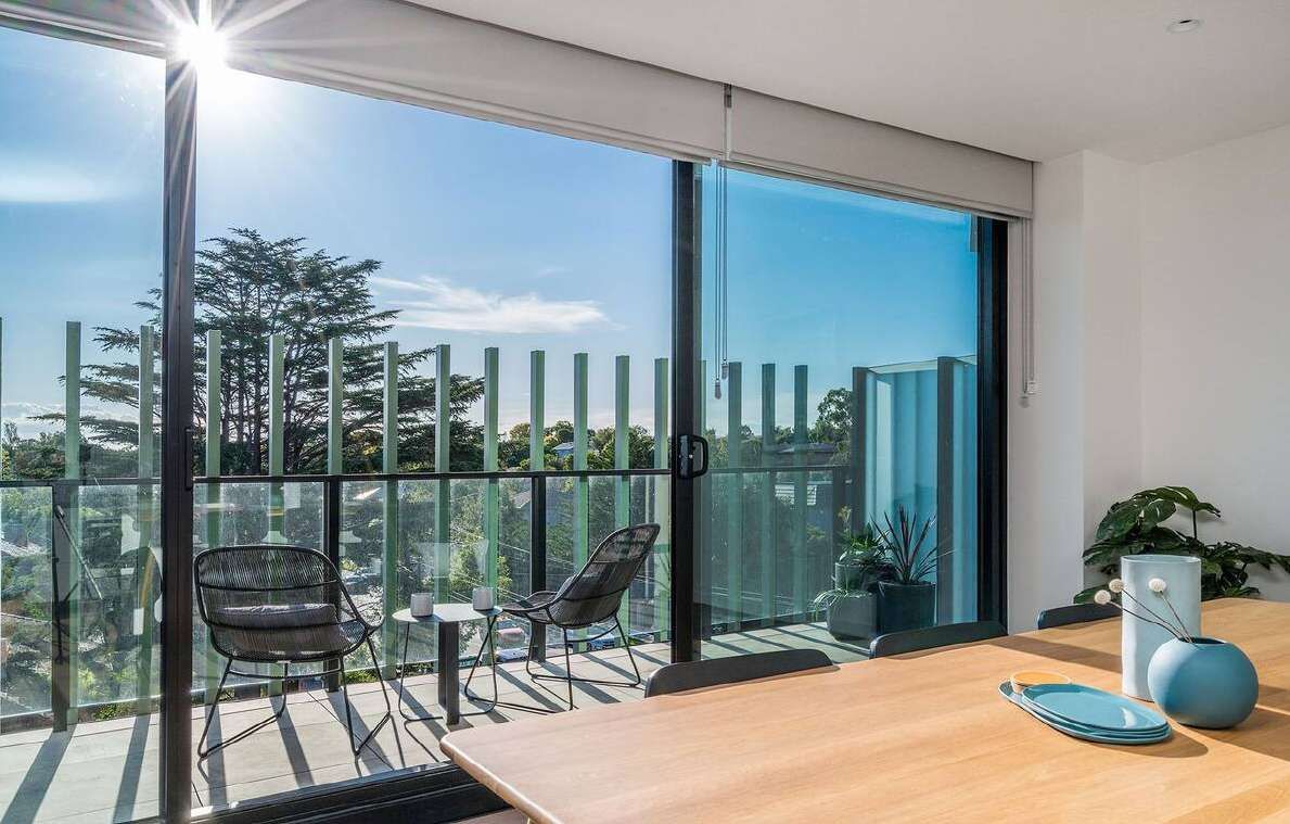 Large glazed sliding doors opening to a balcony